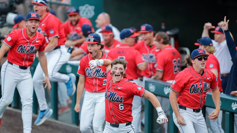 Ole Miss's Owen Paino (6) and teammates react to a 2-run home run by Will Furniss, not...