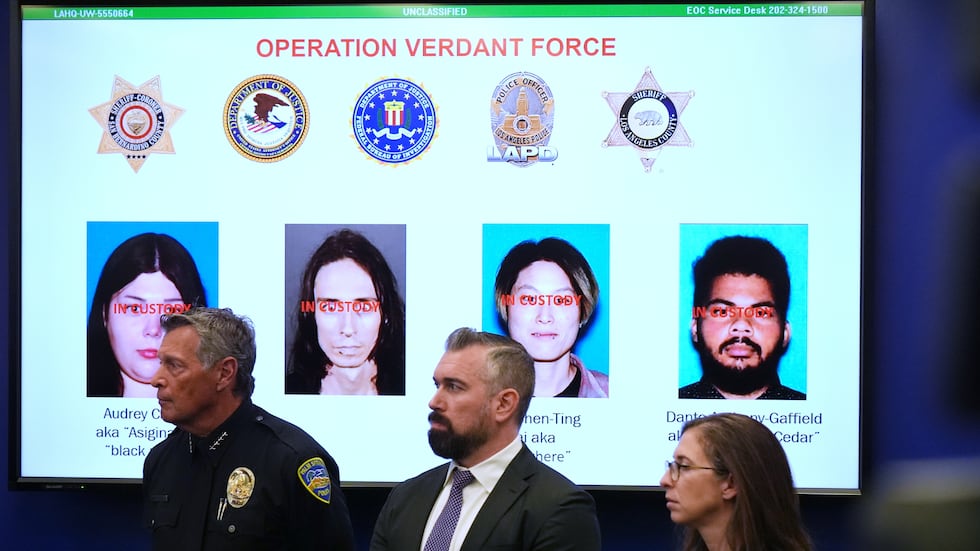 Photos of suspects of a terror plot are shown on a screen during a press conference Monday,...