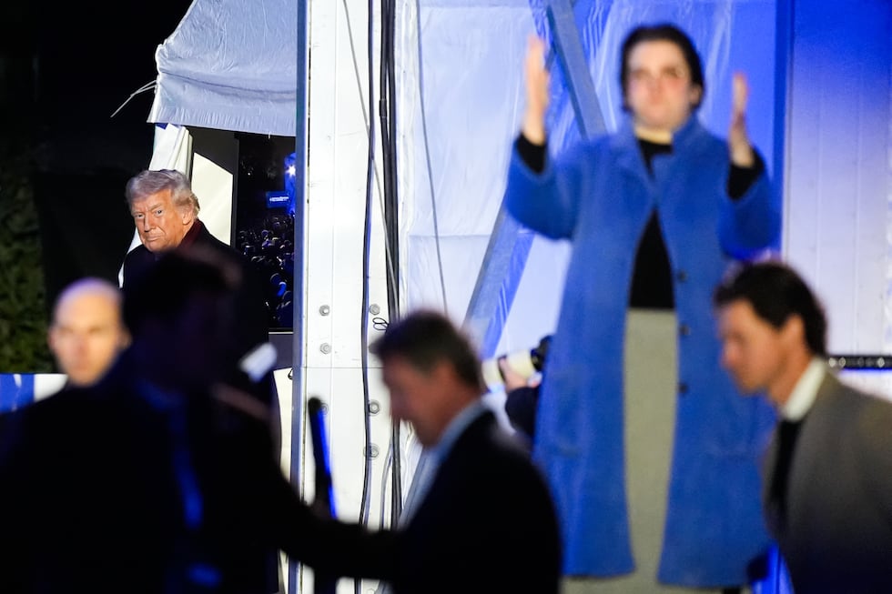An American Sign Language interpreter, right, signs as President Donald Trump arrives for the...