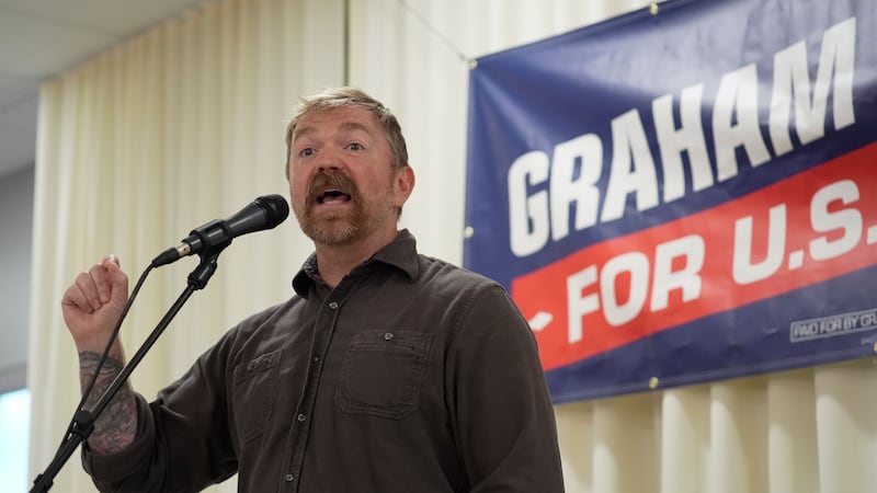 Graham Platner, Democratic candidate for U.S. Senate, speaks to an overflow crowd outside a...