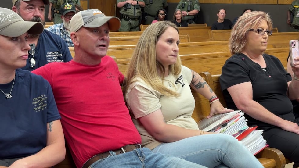 Family members of 15-year-old Tripp Brazeale listen to Sheriff Bobby May explain his reasoning...