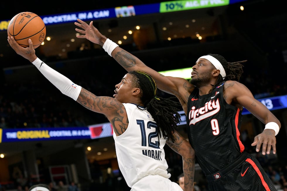 Memphis Grizzlies guard Ja Morant (12) shows ahead of Portland Trail Blazers forward Jerami...