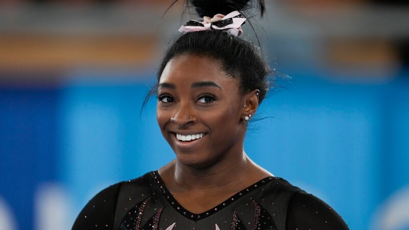 Simone Biles of the United States smiles as she trains for artistic gymnastics at Ariake...