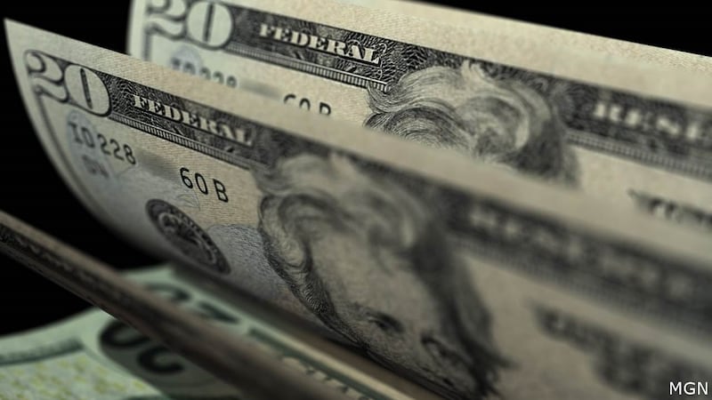 FILE - A bank teller is credited with saving a woman from losing thousands of dollars after...