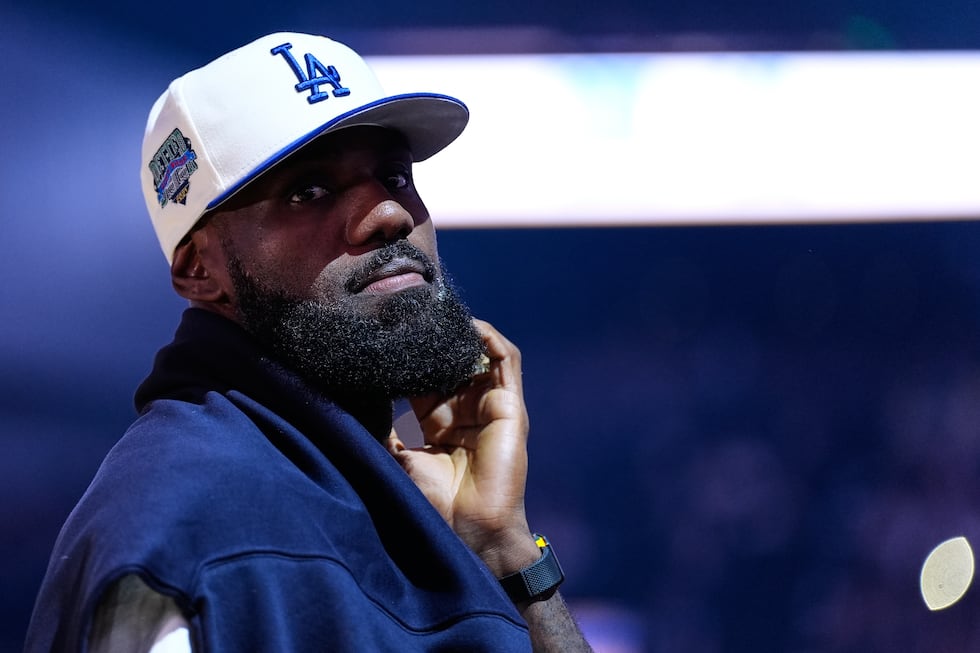Los Angeles Lakers' Lebron James stands on the court before an NBA basketball preseason game...