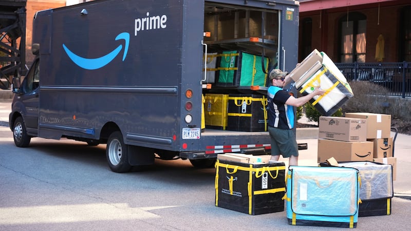 FILE - An Amazon Prime driver makes a delivery outside an apartment building in Pittsburgh,...