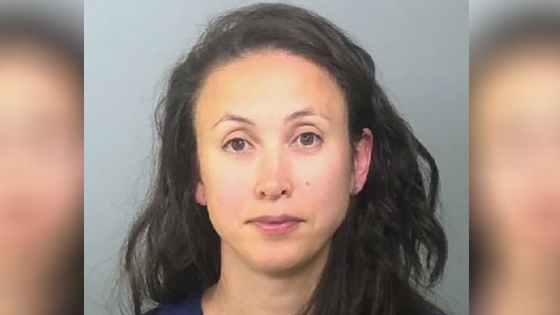 Authorities say a woman was found stopped and asleep behind the wheel of her Tesla in the...