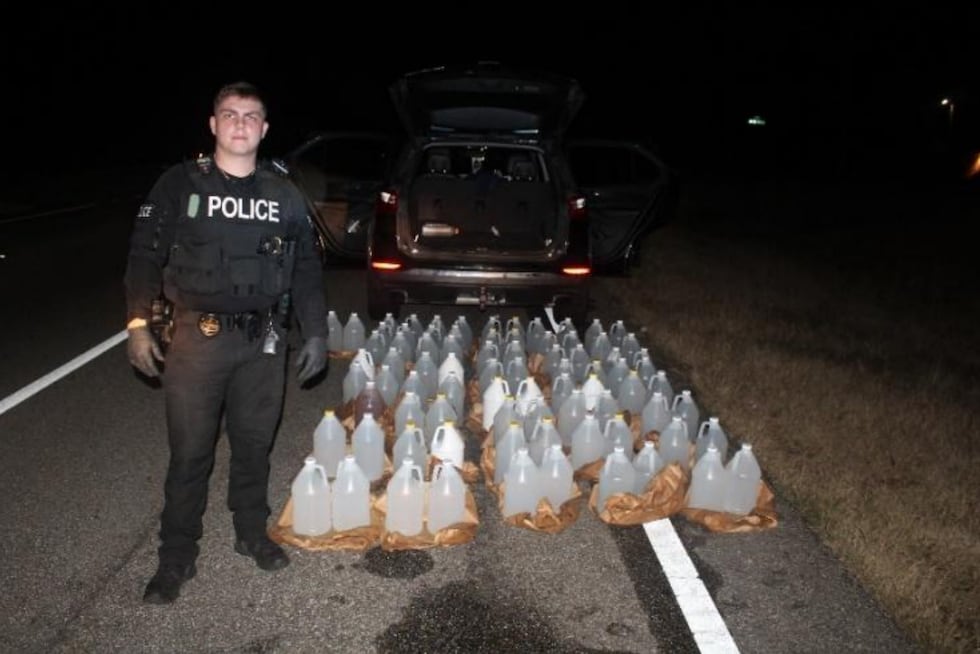 Ozark Police Officer Dylan Griffin uncovered over 80 gallons of illegally distilled moonshine...
